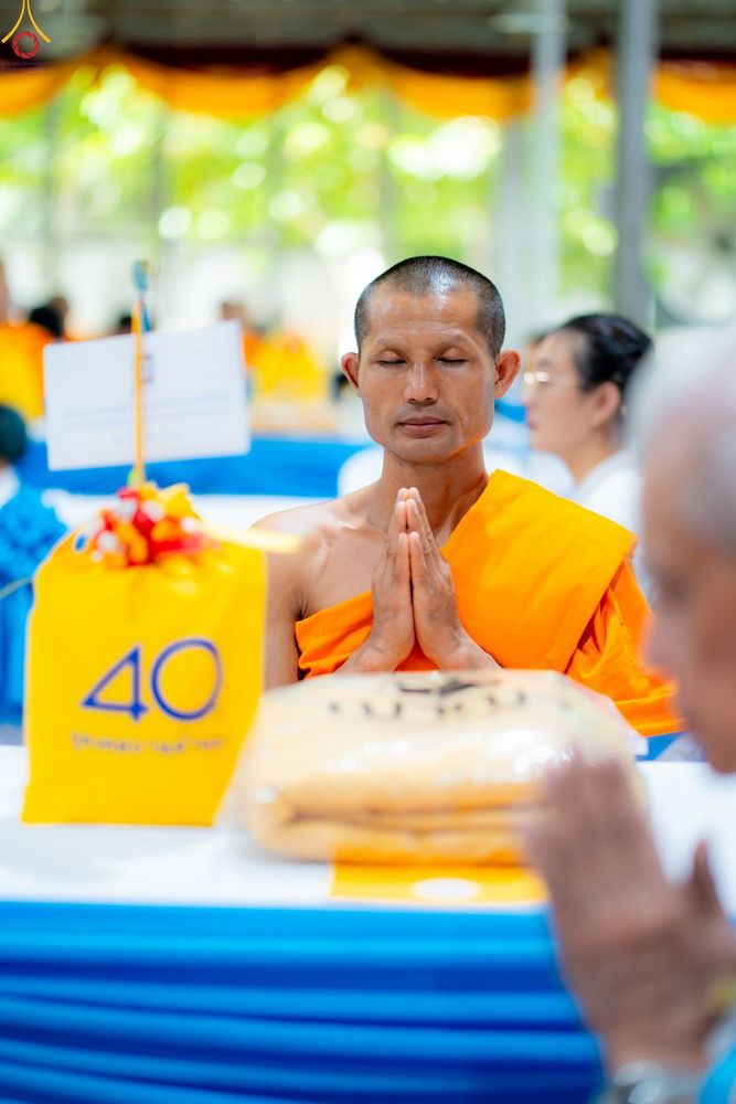 พระภิกษุสงฆ์นั่งพนมมือทำสมาธิในงานบุญครบรอบ 40 ปี