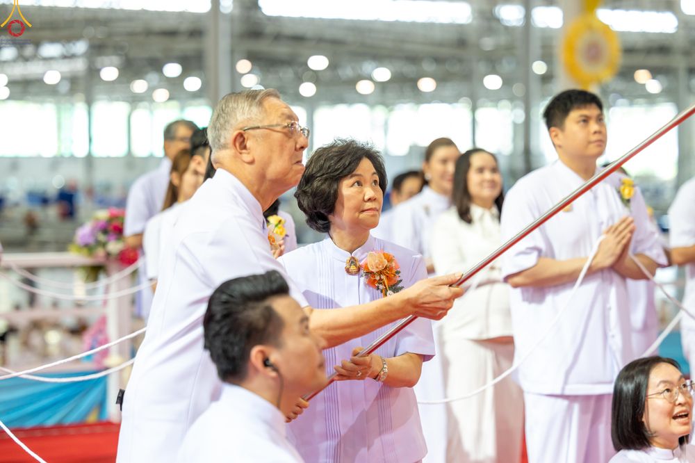 กลุ่มสาธุชนสวมชุดสีขาวกำลังร่วมพิธีจุดเทียนใจ ไฟนิรันดร์ อนันตชัย