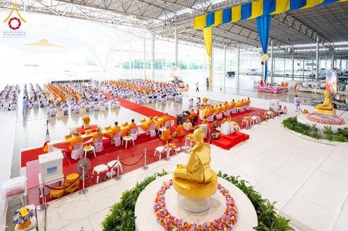 มุมมองมุมสูงภายในสภาธรรมกายสากลที่มีพระภิกษุและสาธุชนนั่งเรียงรายร่วมพิธีทางศาสนา