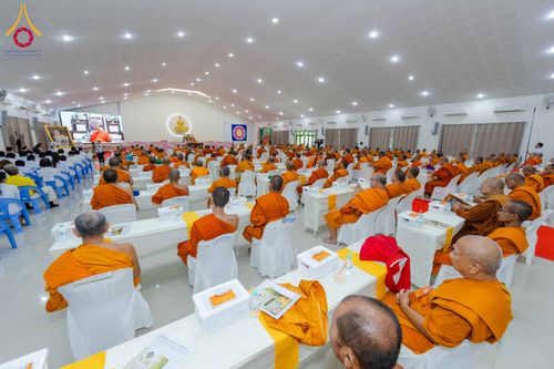 พระภิกษุสงฆ์จำนวนมากนั่งฟังการบรรยายในหอประชุมขนาดใหญ่ที่มีการจัดที่นั่งอย่างเป็นระเบียบ
