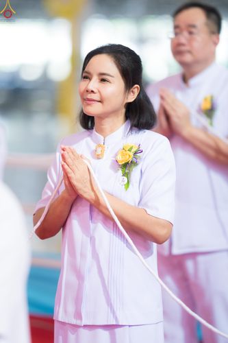 หญิงไทยสวมชุดขาวพนมมือด้วยความสงบในพิธีทางศาสนา