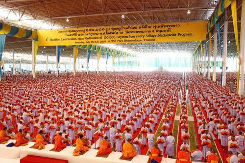 ผู้เข้าร่วมโครงการอุปสมบทหมู่ 1 แสนรูป รุ่นเข้าพรรษา นั่งเรียงแถวอย่างเป็นระเบียบภายในอาคารขนาดใหญ่ ณ วัดพระธรรมกาย